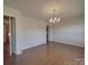 Bright, open living room featuring gleaming hardwood floors and a classic chandelier at 1120 Glenarden Dr, Rock Hill, SC 29730