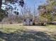 Small outdoor building in an open backyard, with a shed, grass lawn, and a rustic setting at 1120 Glenarden Dr, Rock Hill, SC 29730