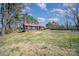 Cozy home with a red roof and spacious yard, surrounded by mature trees in a quiet neighborhood at 127 Barry Oak Rd, Statesville, NC 28625