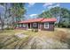 Inviting home with a striking red roof, complemented by brown siding and well-maintained landscaping at 127 Barry Oak Rd, Statesville, NC 28625