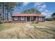 Charming home featuring a red roof, brown siding, and a stone pathway leading to the front door at 127 Barry Oak Rd, Statesville, NC 28625