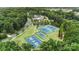 This aerial shot captures various recreational facilities like tennis and basketball courts, nestled among trees at 12726 Rusty Blackbird Way, Charlotte, NC 28278