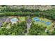 Aerial view showcases community amenities: pool, clubhouse, tennis, and basketball courts amid lush greenery at 12726 Rusty Blackbird Way, Charlotte, NC 28278