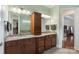 Bathroom features a dual sink vanity, granite countertop, and wooden cabinetry at 12726 Rusty Blackbird Way, Charlotte, NC 28278
