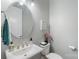 Cozy bathroom with a sink and mirror and fresh flowers at 12726 Rusty Blackbird Way, Charlotte, NC 28278