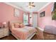 Cozy pink bedroom with a queen size bed and attached study area at 12726 Rusty Blackbird Way, Charlotte, NC 28278