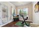 Bright bonus room with wood floors, natural light, an exercise bike, and a door to the exterior at 12726 Rusty Blackbird Way, Charlotte, NC 28278