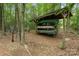 Wood storage rack nestled among trees featuring canoes and kayaks available for use by residents at 12726 Rusty Blackbird Way, Charlotte, NC 28278