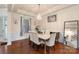Elegant dining room featuring a modern chandelier, a marble dining table set, and hardwood flooring at 12726 Rusty Blackbird Way, Charlotte, NC 28278