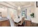 Elegant dining room featuring a modern chandelier, a marble dining table set, and hardwood flooring at 12726 Rusty Blackbird Way, Charlotte, NC 28278