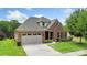Charming brick home features a manicured lawn, attached garage, and inviting front entrance with manicured landscaping at 12726 Rusty Blackbird Way, Charlotte, NC 28278
