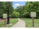 A paved trail is surrounded by lush greenery and marked by clear signage indicating its private status at 12726 Rusty Blackbird Way, Charlotte, NC 28278