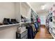 Walk-in closet with shoe shelves, hanging racks, and wooden floors at 12726 Rusty Blackbird Way, Charlotte, NC 28278