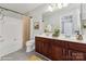 Well-lit bathroom featuring a double vanity, tub with shower, and modern fixtures at 12727 Bullock Greenway Blvd, Charlotte, NC 28277