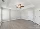 Bright bedroom features a tray ceiling, ceiling fan, natural light, and neutral color palette at 12727 Bullock Greenway Blvd, Charlotte, NC 28277