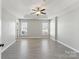 Large bedroom with a tray ceiling, fan, neutral color palette, and ample natural light at 12727 Bullock Greenway Blvd, Charlotte, NC 28277