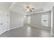 Spacious bedroom featuring a tray ceiling, ceiling fan, neutral walls, and natural light from windows at 12727 Bullock Greenway Blvd, Charlotte, NC 28277