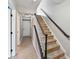 View of a home entryway with carpeted stairs and white doors with black hardware at 12727 Bullock Greenway Blvd, Charlotte, NC 28277