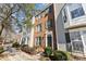 Charming two-story townhome with brick facade, neutral siding, professionally landscaped front yard, and sidewalk at 12727 Bullock Greenway Blvd, Charlotte, NC 28277