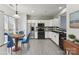 Modern kitchen with white cabinets, stainless steel appliances, and an adjacent breakfast nook at 12727 Bullock Greenway Blvd, Charlotte, NC 28277