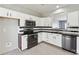 Modern kitchen showcasing white cabinetry, stainless steel appliances, and sleek black countertops and backsplash at 12727 Bullock Greenway Blvd, Charlotte, NC 28277