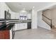 Open concept kitchen with a view, white cabinets, black countertop, and stainless steel dishwasher and stove at 12727 Bullock Greenway Blvd, Charlotte, NC 28277