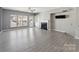 Bright living room with a fireplace, built-in shelves, and many windows at 12727 Bullock Greenway Blvd, Charlotte, NC 28277