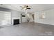 Open-concept living room with a fireplace and stairs nearby at 12727 Bullock Greenway Blvd, Charlotte, NC 28277