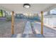 Covered patio overlooking large backyard, complemented by bright yellow daffodils at 1605 5Th St, Statesville, NC 28625