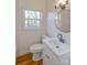 Bright bathroom features a modern vanity, updated fixtures, and stylish round mirror at 1605 5Th St, Statesville, NC 28625