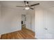 Bedroom with ceiling fan and door to additional room with hardwood floors at 1605 5Th St, Statesville, NC 28625