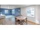 Inviting dining area featuring stylish flooring, blue walls, and an abundance of natural light from large windows at 1605 5Th St, Statesville, NC 28625