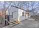 Exterior showcasing a white house with stairs leading to an elevated porch and a covered patio at 1605 5Th St, Statesville, NC 28625