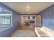 Bright living room featuring wood floors, blue walls, and an open floor plan leading to the dining area at 1605 5Th St, Statesville, NC 28625