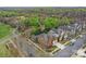 Aerial view of a brick home with a lush, wooded area in the background at 16620 Redding Park Ln, Cornelius, NC 28031