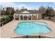 Aerial view of a community pool and clubhouse surrounded by trees at 16620 Redding Park Ln, Cornelius, NC 28031