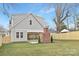 Well-maintained backyard with a brick fireplace, new fence, and sliding doors to the house at 1817 S Mint St, Charlotte, NC 28203