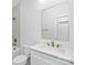 Bright bathroom with a combination tub and shower, single vanity, and a framed mirror at 1817 S Mint St, Charlotte, NC 28203