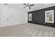 Spacious bedroom with carpet, two windows, a ceiling fan, and a black accent wall at 1817 S Mint St, Charlotte, NC 28203