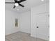 A bedroom with clean white walls, neutral carpet, a window, and a ceiling fan at 1817 S Mint St, Charlotte, NC 28203