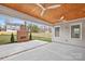 Relaxing covered patio features a brick fireplace, ceiling fans, wood ceiling, and a fenced yard at 1817 S Mint St, Charlotte, NC 28203