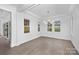 Bright dining room with modern chandelier and view to the fireplace and backyard through glass patio doors at 1817 S Mint St, Charlotte, NC 28203