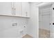 Laundry room with modern white cabinetry, shelving, and new washer/dryer hookups at 1817 S Mint St, Charlotte, NC 28203