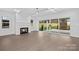 Bright living room with hardwood floors, a fireplace, and sliding doors to outdoor space at 1817 S Mint St, Charlotte, NC 28203