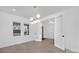 Home office features large windows, a modern chandelier, and a glass door to another room at 1817 S Mint St, Charlotte, NC 28203