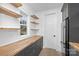 Pantry with butcher block countertops, wood floating shelves, and easy access to kitchen appliances at 1817 S Mint St, Charlotte, NC 28203