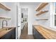 Pantry featuring custom cabinets with butcher block countertop and wood floating shelves for storage at 1817 S Mint St, Charlotte, NC 28203