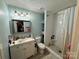 Bathroom featuring a white vanity, framed mirror, shower with white subway tile and glass door at 2027 Downey St, Rock Hill, SC 29732