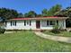 Charming one-story home features a red roof, light siding, and a well-manicured lawn at 2027 Downey St, Rock Hill, SC 29732