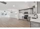 Open concept kitchen with grey cabinets, stainless steel appliances, and a view to the living area at 219 E Rice St, Landis, NC 28088